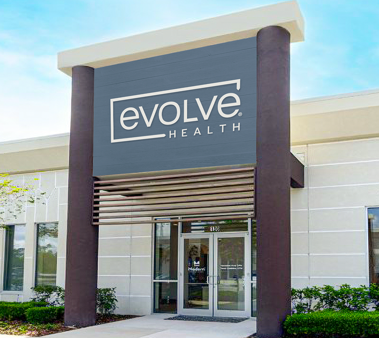 Exterior view of an Evolve Health clinic with logo sign above the entrance